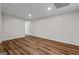 View of the finished basement space with modern flooring and lighting at 1124 Ponderosa Park Dr, Forest Park, GA 30297