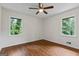 Bedroom with hardwood floors, natural light from windows, and ceiling fan at 1124 Ponderosa Park Dr, Forest Park, GA 30297