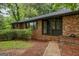 Brick home featuring a covered front porch and beautiful landscaping at 1124 Ponderosa Park Dr, Forest Park, GA 30297