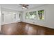 Cozy living room featuring hardwood floors, a ceiling fan and large windows, offering ample natural light at 1124 Ponderosa Park Dr, Forest Park, GA 30297