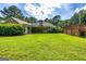 Expansive backyard with lush lawn, covered patio, and wooden deck for outdoor enjoyment at 130 Laurel Lake Rd, Tyrone, GA 30290
