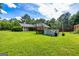 Large backyard with a pool, wooden deck, and spacious grassy area perfect for entertaining at 130 Laurel Lake Rd, Tyrone, GA 30290