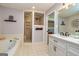 Bright bathroom with a soaking tub, tiled shower, and modern vanity at 130 Laurel Lake Rd, Tyrone, GA 30290