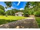 Scenic property featuring a long driveway, lush greenery, and beautiful landscaping at 130 Laurel Lake Rd, Tyrone, GA 30290