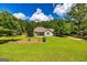Landscaped front yard featuring a well-maintained lawn and charming exterior at 130 Laurel Lake Rd, Tyrone, GA 30290