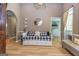 Open living room featuring a day bed, arched doorway, and stylish decor at 130 Laurel Lake Rd, Tyrone, GA 30290