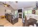 Relaxing living room showcasing a fireplace, large windows, and vaulted ceiling at 130 Laurel Lake Rd, Tyrone, GA 30290