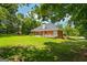 Brick home with a patio and large backyard, surrounded by lush trees for added privacy at 40 Costleys Bridge Dr, Oxford, GA 30054