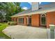 Brick home featuring a spacious back patio, perfect for entertaining or enjoying the outdoors at 40 Costleys Bridge Dr, Oxford, GA 30054