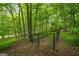 A fenced in area in the wooded backyard, ideal for pets at 40 Costleys Bridge Dr, Oxford, GA 30054