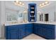Stylish bathroom with dual sinks, blue cabinetry, and well-lit mirrors, providing a functional and aesthetically pleasing space at 40 Costleys Bridge Dr, Oxford, GA 30054