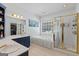 Bright bathroom featuring a soaking tub, glass-enclosed shower, and ample counter space, perfect for a luxurious experience at 40 Costleys Bridge Dr, Oxford, GA 30054
