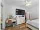 This bedroom features wood floors, ceiling fan, vanity and large television at 40 Costleys Bridge Dr, Oxford, GA 30054