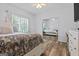 This bright bedroom features wood floors, large window, and mirrored closet at 40 Costleys Bridge Dr, Oxford, GA 30054