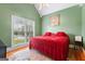 Cozy bedroom with vaulted ceiling, large window, and a comfortable red bed at 40 Costleys Bridge Dr, Oxford, GA 30054