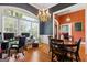 Formal dining room featuring hardwood floors, chandelier, and ample natural light at 40 Costleys Bridge Dr, Oxford, GA 30054