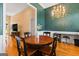 Dining room with a chandelier, hardwood floors and space for a home office setup at 40 Costleys Bridge Dr, Oxford, GA 30054