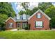 Charming red brick home with black shutters, dormers, and manicured lawn at 40 Costleys Bridge Dr, Oxford, GA 30054