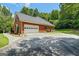 Side view of a brick home, with a spacious garage and well-maintained landscaping at 40 Costleys Bridge Dr, Oxford, GA 30054