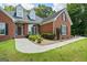 Well-maintained brick home featuring an arched entryway and walkway with lush landscaping at 40 Costleys Bridge Dr, Oxford, GA 30054