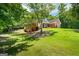 Brick home featuring an expansive, well-manicured lawn shaded by mature trees, offering a serene outdoor setting at 40 Costleys Bridge Dr, Oxford, GA 30054
