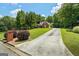 Classic brick home with a long driveway and lush green lawn, creating a welcoming curb appeal at 40 Costleys Bridge Dr, Oxford, GA 30054