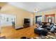 Spacious living room featuring hardwood floors, recessed lighting, and an open floor plan leading to dining and entryway at 40 Costleys Bridge Dr, Oxford, GA 30054