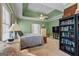 Inviting bedroom with a tray ceiling, built-in bookcase, and serene ambiance perfect for relaxation and restful nights at 40 Costleys Bridge Dr, Oxford, GA 30054
