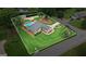 Expansive aerial view of home highlighting the landscaped lawn and refreshing swimming pool at 15 Livingston Way, Covington, GA 30016