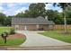 View of the rear exterior showcasing neutral siding, ample windows, and lush landscaping at 15 Livingston Way, Covington, GA 30016