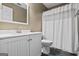 Bright bathroom with a white vanity, toilet, and shower at 15 Livingston Way, Covington, GA 30016