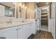 Bathroom featuring double vanity, updated fixtures, and a view into the closet at 15 Livingston Way, Covington, GA 30016
