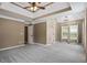 Spacious Primary bedroom showcasing a tray ceiling and large windows at 15 Livingston Way, Covington, GA 30016