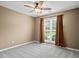 Comfortable bedroom featuring a ceiling fan and a large window at 15 Livingston Way, Covington, GA 30016
