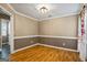 The dining room has warm wood floors and wainscoting offering an ideal space for entertaining at 15 Livingston Way, Covington, GA 30016