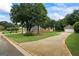 Long driveway leads to home featuring a well-maintained lawn and landscaping at 15 Livingston Way, Covington, GA 30016