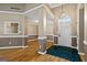 Grand foyer with hardwood floors, classic wainscoting, and a stylish chandelier provides an elegant entry to the home's living spaces at 15 Livingston Way, Covington, GA 30016