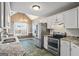 Well-equipped kitchen features stainless steel appliances and granite countertops, blending style with functionality for culinary enthusiasts at 15 Livingston Way, Covington, GA 30016
