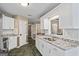 Bright kitchen featuring white cabinetry, granite countertops, and stainless steel appliances at 15 Livingston Way, Covington, GA 30016