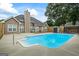 Sparkling backyard pool with concrete surround, adjacent to the home's rear exterior and fencing at 15 Livingston Way, Covington, GA 30016