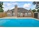Backyard pool and deck provide a tranquil and refreshing retreat, complemented by the home's rear exterior at 15 Livingston Way, Covington, GA 30016