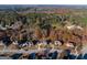Aerial shot displays a neighborhood with mature landscaping and tree-lined streets surrounded by nature at 355 Woodbyne Dr, Fayetteville, GA 30214