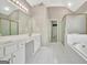 Bathroom featuring double sinks, shower, bath tub and tiled floor at 355 Woodbyne Dr, Fayetteville, GA 30214