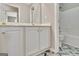 Bathroom with white vanity, grey herringbone tile floor, and a shower/tub combo with tile surround at 355 Woodbyne Dr, Fayetteville, GA 30214
