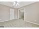 Bedroom with neutral carpet, ceiling fan, and access to the next room at 355 Woodbyne Dr, Fayetteville, GA 30214
