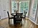 Sunlit dining area with a round table, hardwood floors, and large windows at 355 Woodbyne Dr, Fayetteville, GA 30214