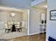 Open-concept view of the elegant dining room with wainscoting, chandelier and open access to living spaces at 355 Woodbyne Dr, Fayetteville, GA 30214