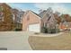 Charming home featuring a spacious driveway leading to an attached garage and manicured landscaping at 355 Woodbyne Dr, Fayetteville, GA 30214