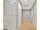 Bright hallway with wood-look floors and multiple storage closets at 355 Woodbyne Dr, Fayetteville, GA 30214