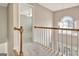 Bright hallway featuring plush carpeting, a window and chandelier, and an open doorway to the next room at 355 Woodbyne Dr, Fayetteville, GA 30214